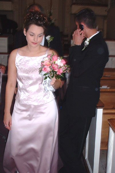 The Ceremony- Stephanie looks at her flowers while Michanel talks on the phone.jpg 53.5K